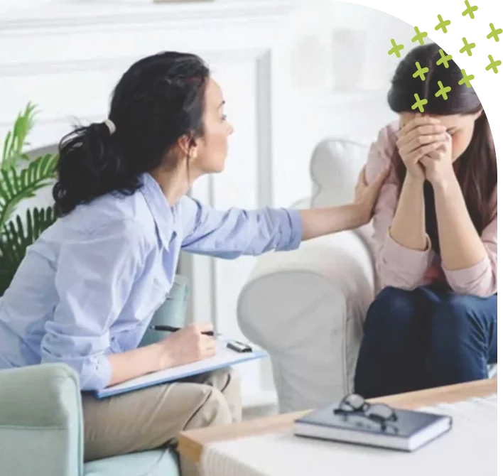 Therapist consoling emotional woman in session