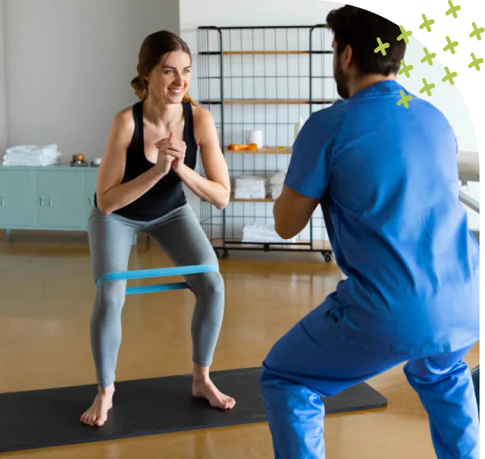 Physical therapy session with trainer helping woman exercise