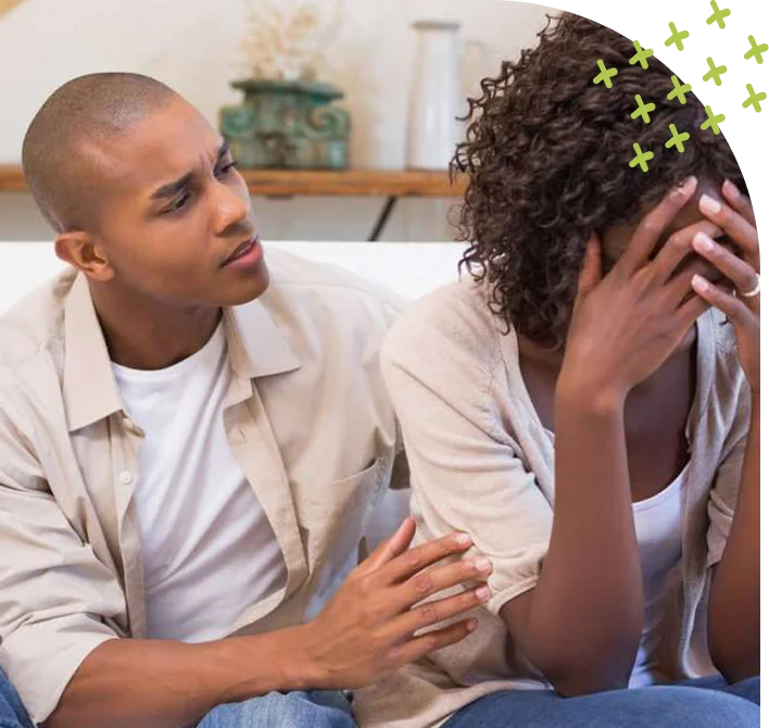 Man consoling distressed woman at home