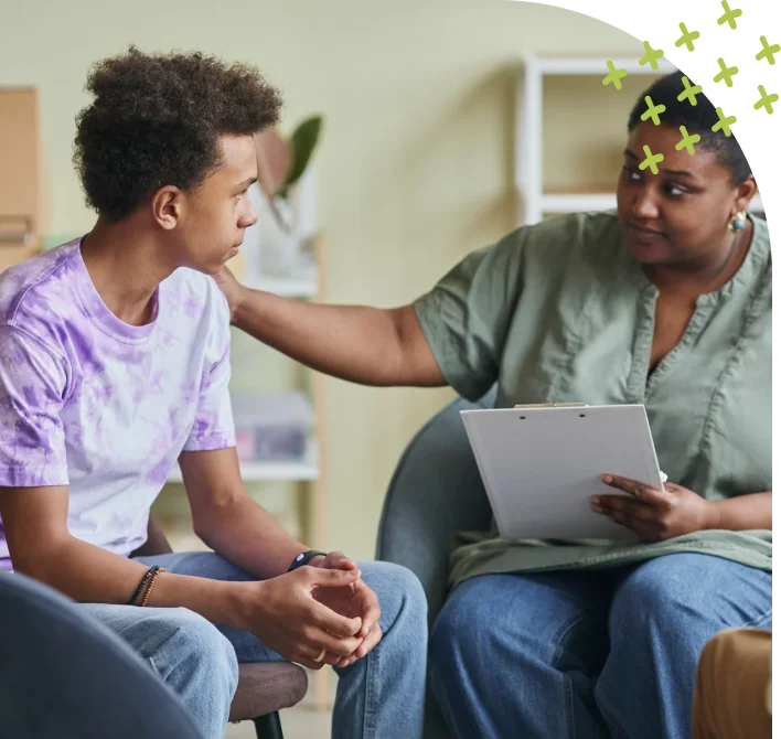 Supportive therapist guiding teenager during mental health session